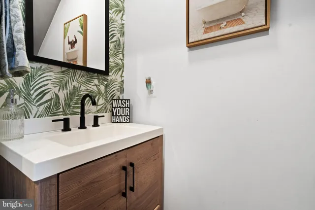 a bathroom with a sink vanity and a