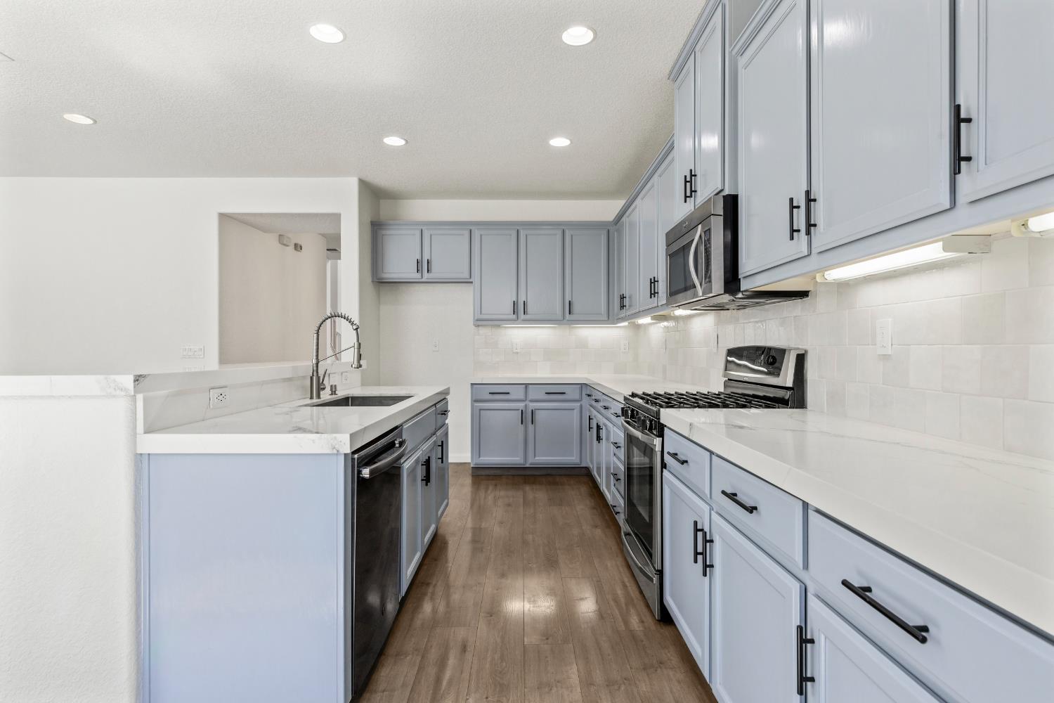2836 Tabriz Drive Modesto, CA 95355 - Photo 11 of 35 a kitchen with stainless steel appliances granite countertop a sink stove and refrigerator