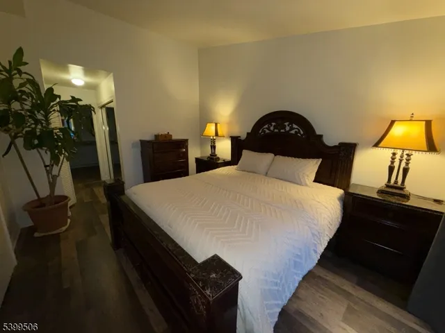 a bedroom with a bed and a lamp on table