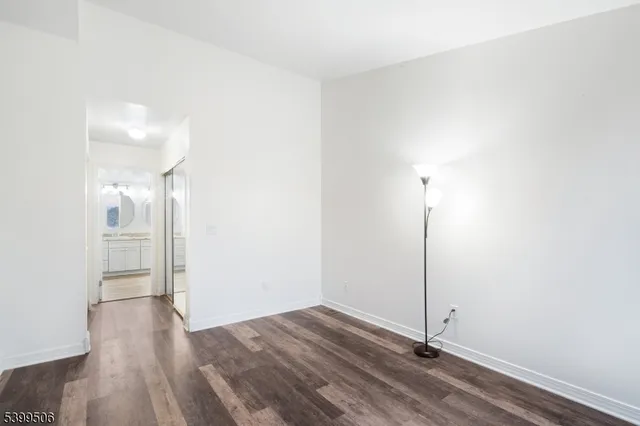 a view of a room with wooden floor
