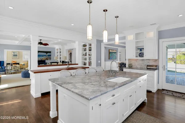 a kitchen with sink stove and wooden floor