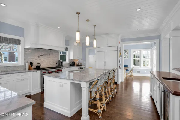 a view of a dining room with furniture a chandelier and wooden floor