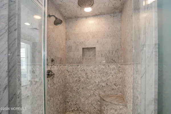 a spacious bathroom with a tub double sink and window