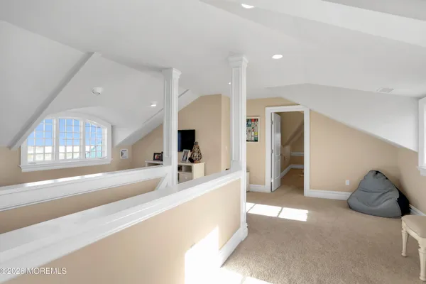 a living room with furniture kitchen view and a flat screen tv