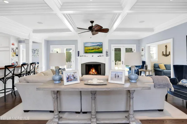 a living room with fireplace furniture and a wooden floor