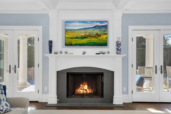 a living room with a fireplace a flat screen tv and a fireplace