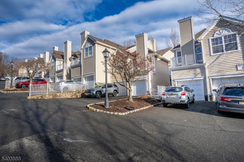 a view of a street that has couple of cars parked on the road