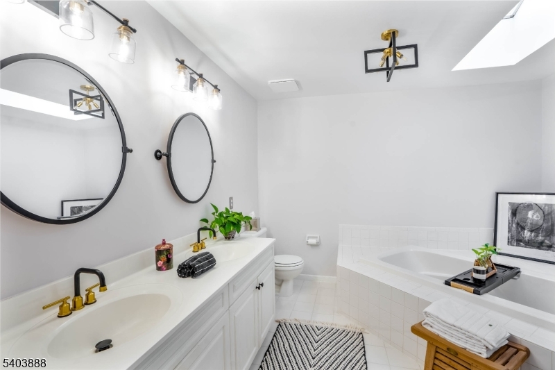 8 Springholm Drive Berkeley Heights, NJ 07922 - Photo 4 of 19 a bathroom with a sink mirror and tub