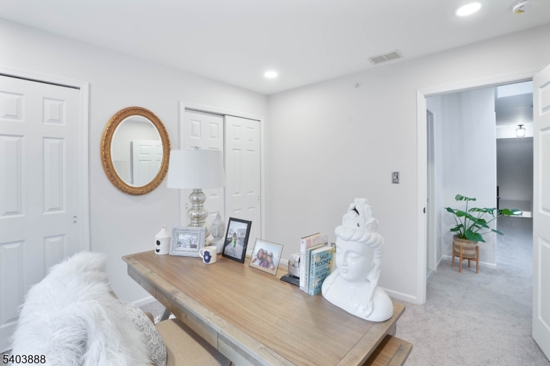 8 Springholm Drive Berkeley Heights, NJ 07922 - Photo 7 of 19 a room with a large bed and a chandelier