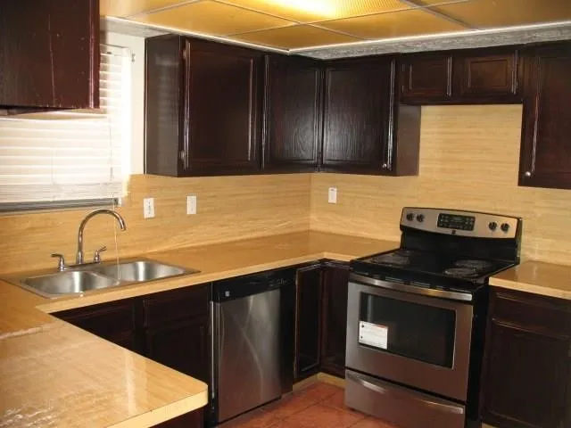 a kitchen with a sink and a stove top oven