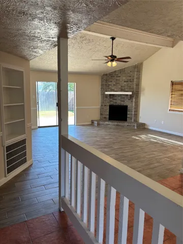 a view of an empty room and fire place