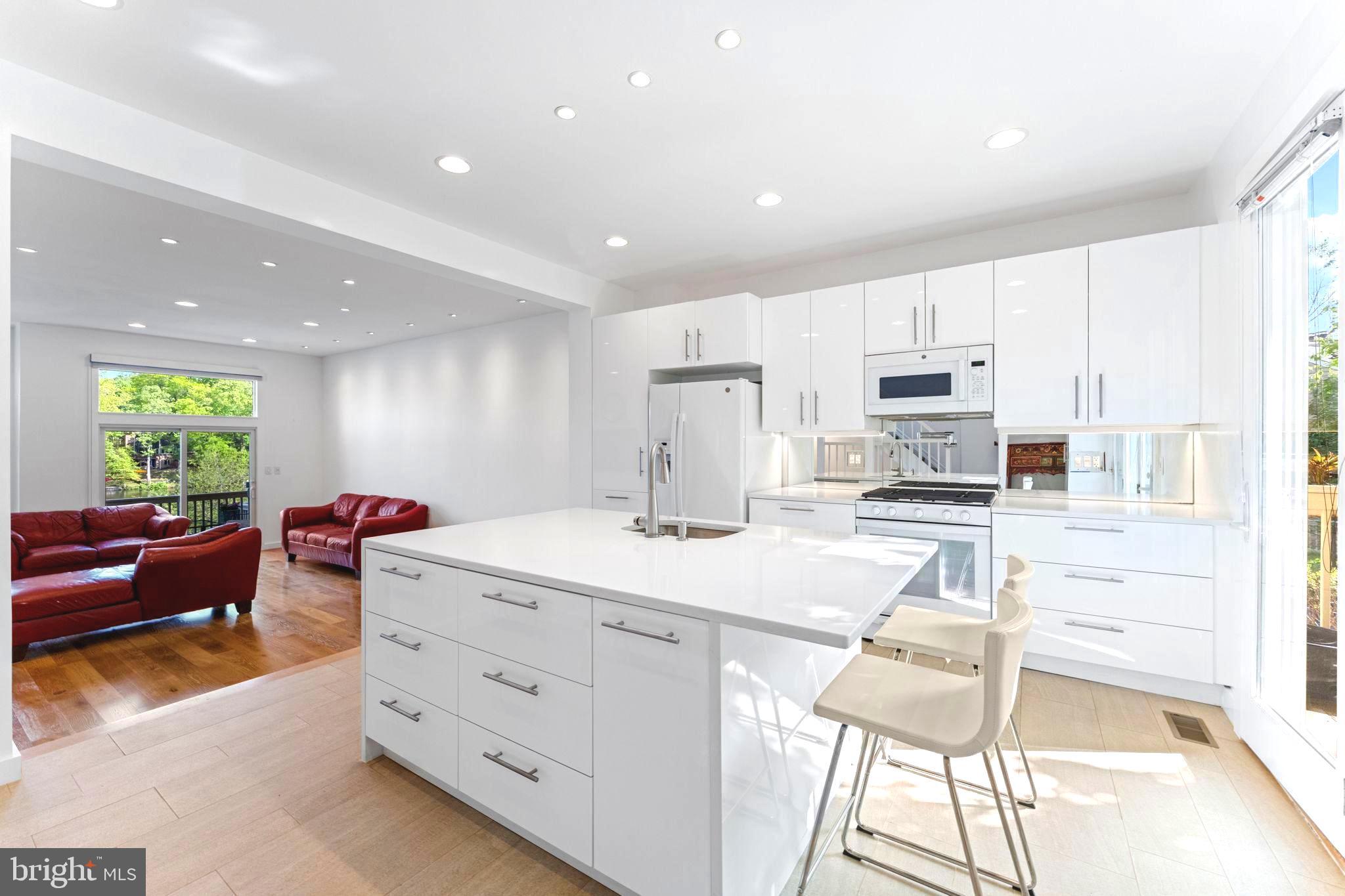 11163 Lake Chapel Lane Reston, VA 20191 - Photo 18 of 129 a kitchen with stainless steel appliances kitchen island granite countertop a sink and cabinets
