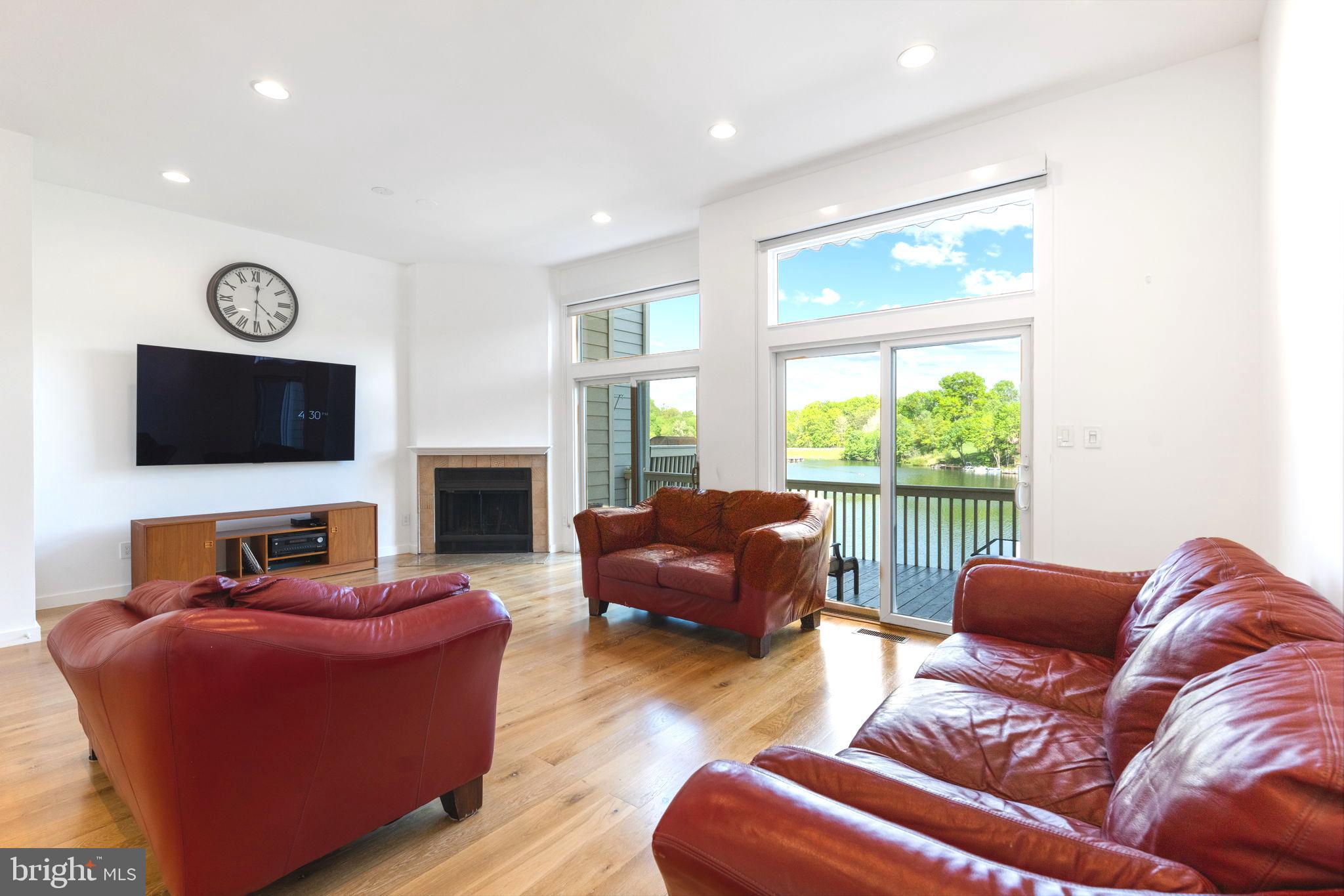 11163 Lake Chapel Lane Reston, VA 20191 - Photo 25 of 129 a living room with furniture a flat screen tv and a fireplace