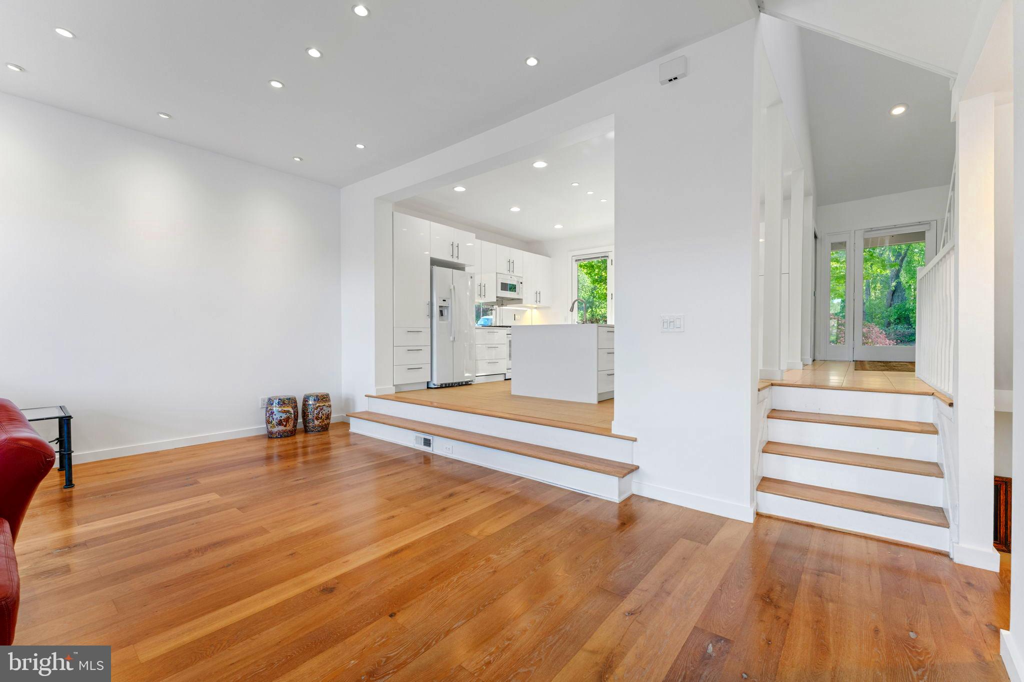11163 Lake Chapel Lane Reston, VA 20191 - Photo 28 of 129 a view of an empty room with wooden floor and a potted plant