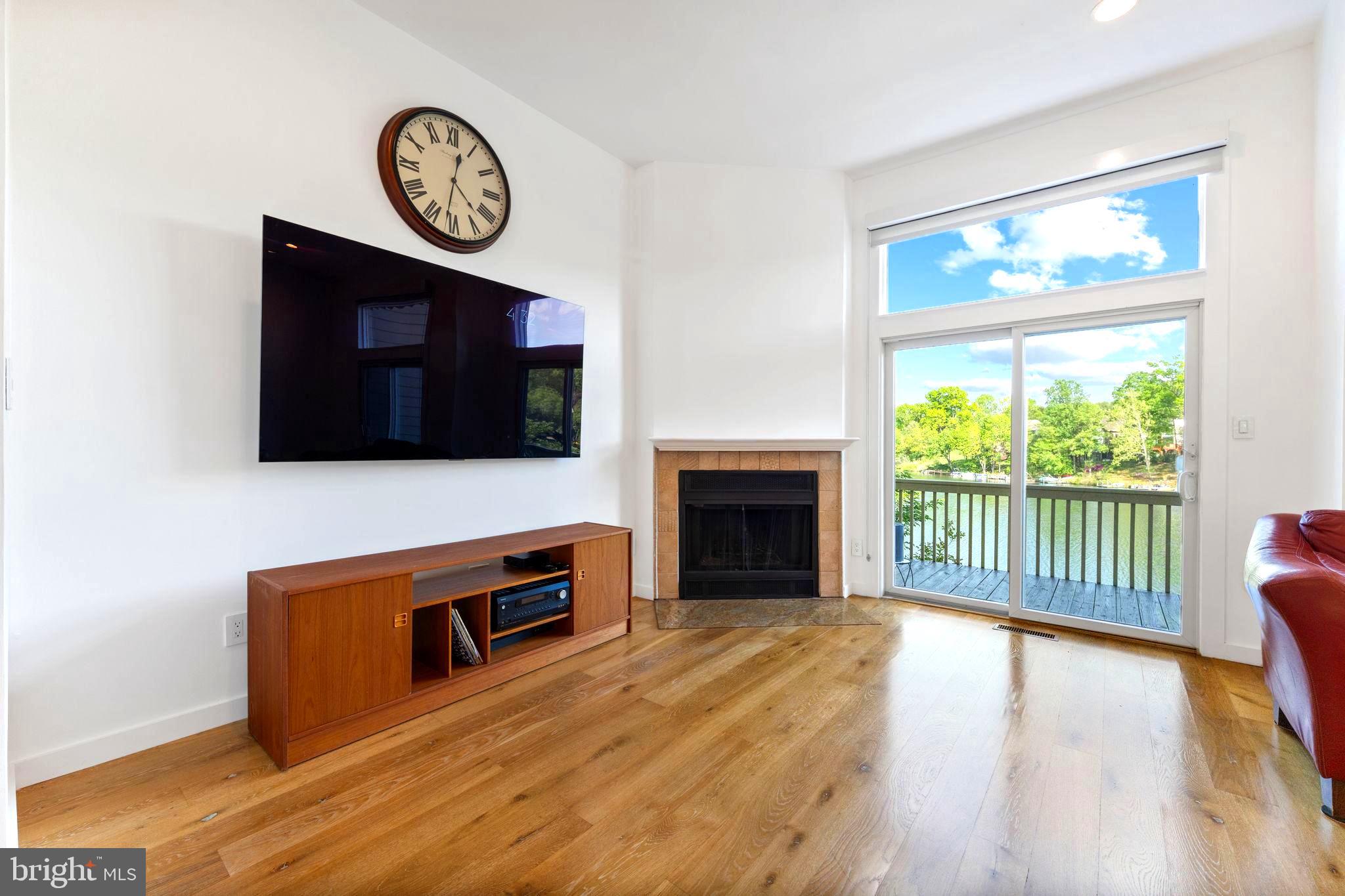 11163 Lake Chapel Lane Reston, VA 20191 - Photo 31 of 129 a view of a livingroom with furniture wooden floor and a fireplace
