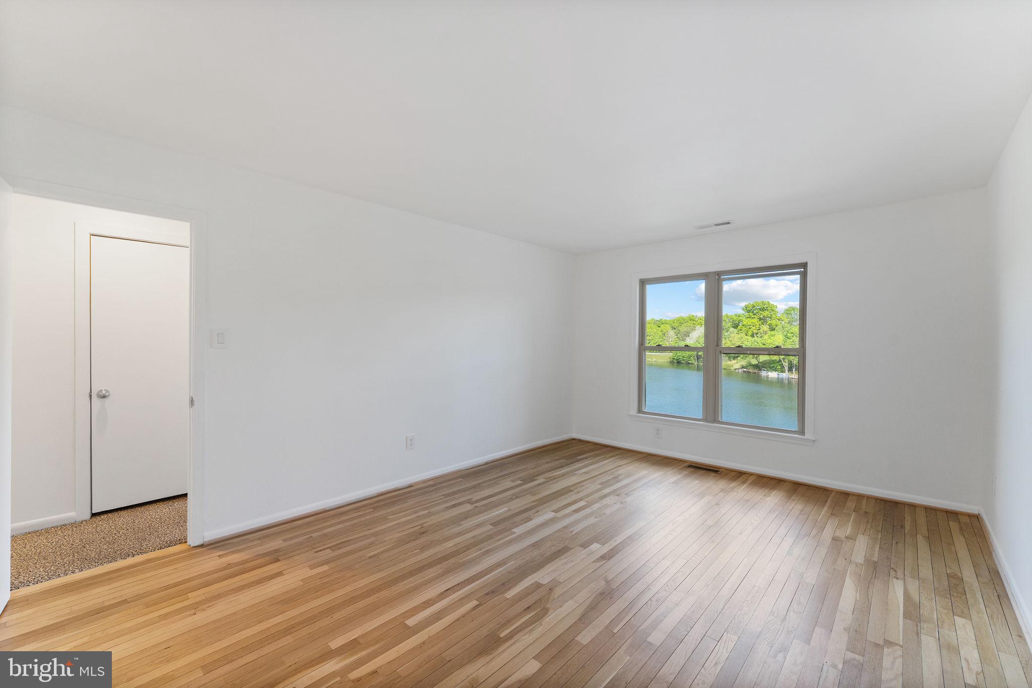 11163 Lake Chapel Lane Reston, VA 20191 - Photo 44 of 129 an empty room with wooden floor and windows