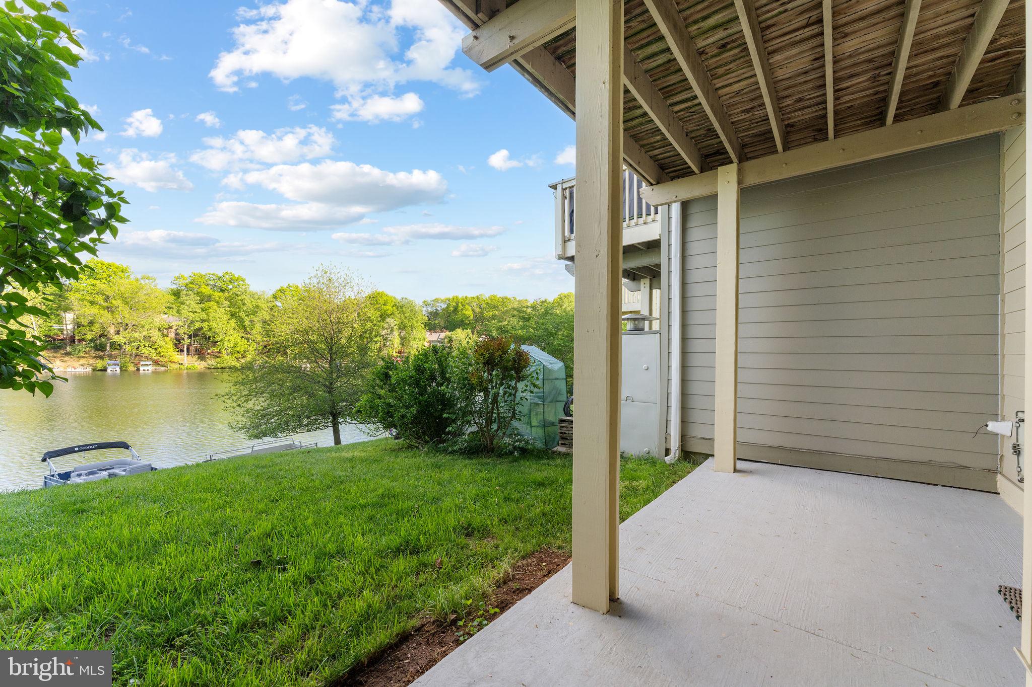 11163 Lake Chapel Lane Reston, VA 20191 - Photo 77 of 129 a backyard of a house with plants and lake view