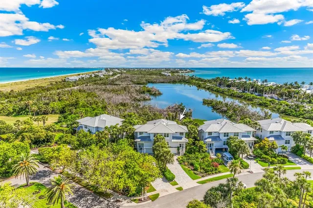 a view of a city with lots of residential buildings ocean and mountain view in back