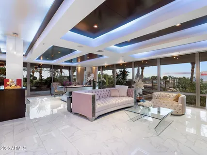 a view of a dining room with furniture a chandelier and wooden floor