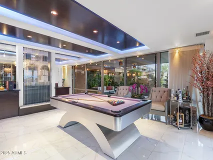 a kitchen with stainless steel appliances kitchen island granite countertop a table and chairs