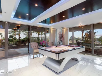 a kitchen with stainless steel appliances granite countertop a sink dishwasher and a refrigerator with wooden floor