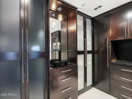 a view of a house with a yard and potted plants