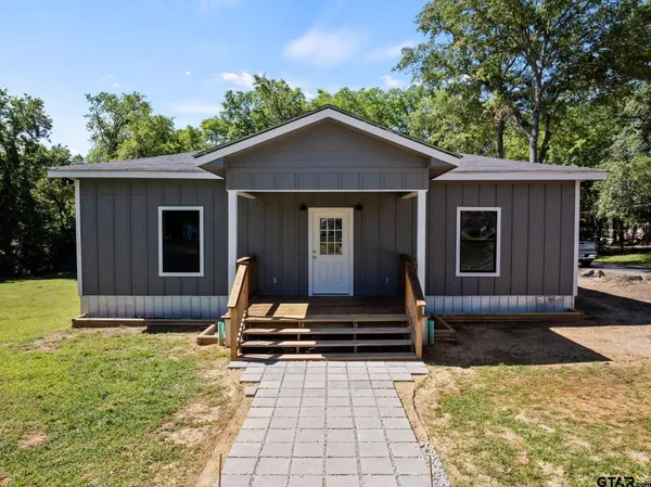 a view of house with backyard and garden