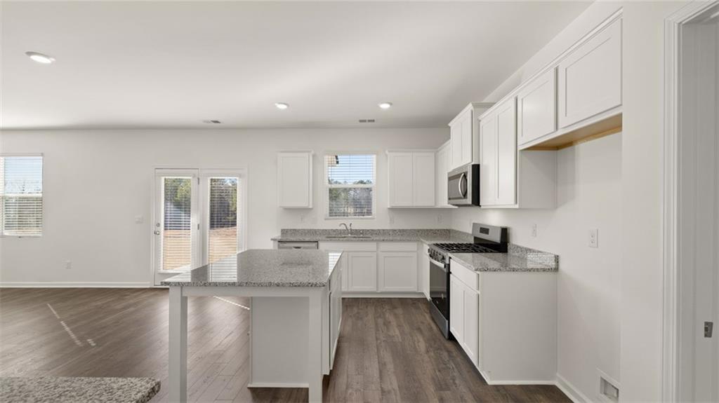 73 Weymouth Drive Locust Grove, GA 30248 - Photo 11 of 47 a kitchen with sink stove and cabinets