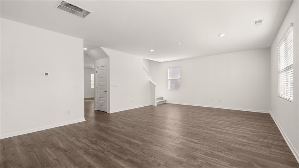 73 Weymouth Drive Locust Grove, GA 30248 - Photo 18 of 47 an empty room with wooden floor and windows