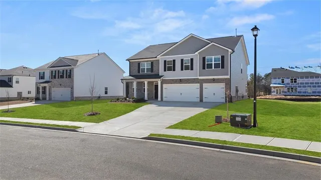 a front view of a house with a yard and garage