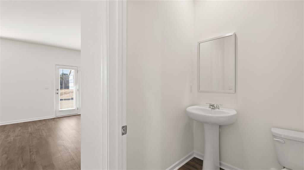 73 Weymouth Drive Locust Grove, GA 30248 - Photo 21 of 47 a bathroom with a sink toilet and a mirror