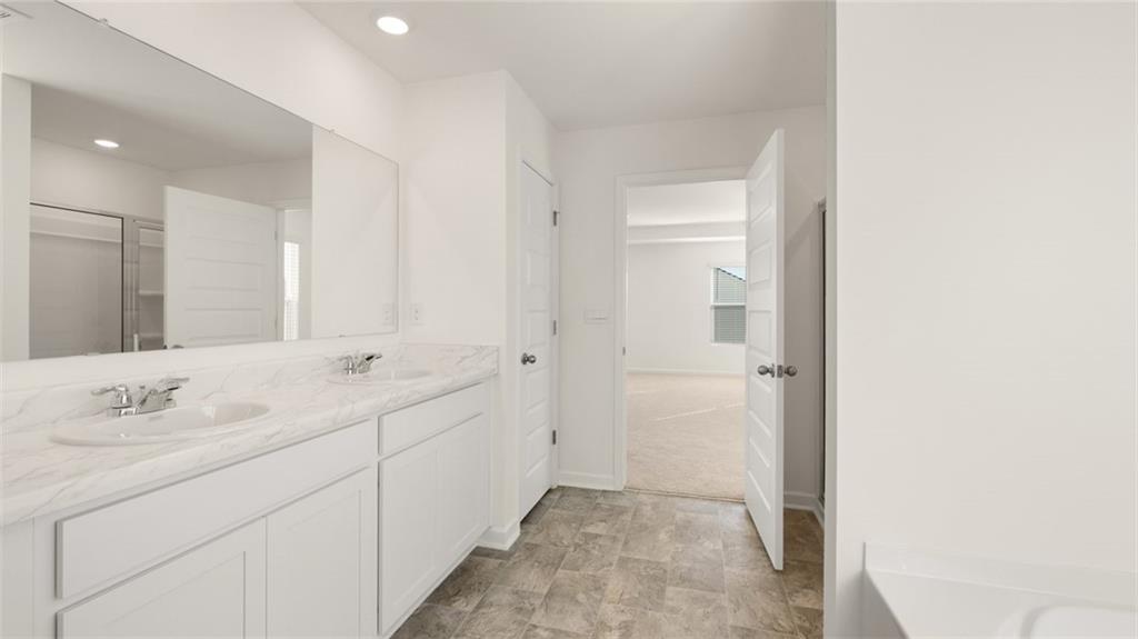 73 Weymouth Drive Locust Grove, GA 30248 - Photo 30 of 47 a bathroom with a double vanity sink and mirror