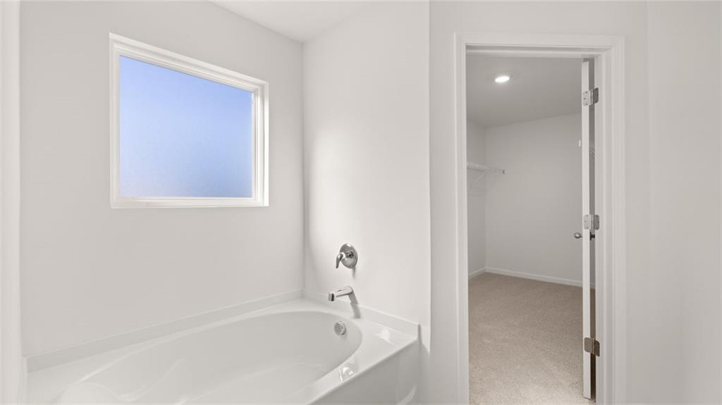 73 Weymouth Drive Locust Grove, GA 30248 - Photo 31 of 47 a white bath tub sitting in a bathroom