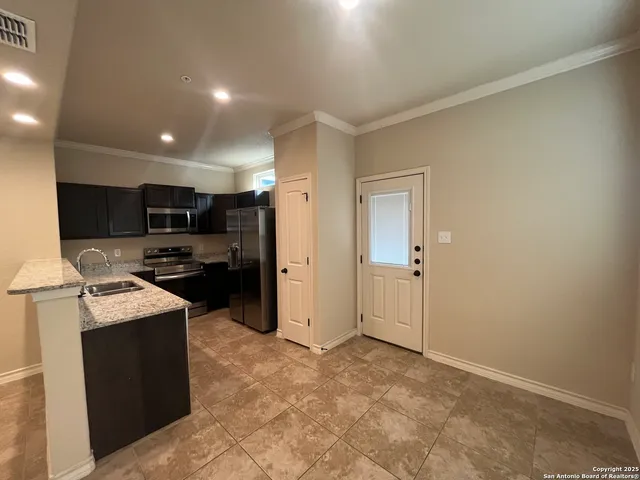 a kitchen with refrigerator and cabinets