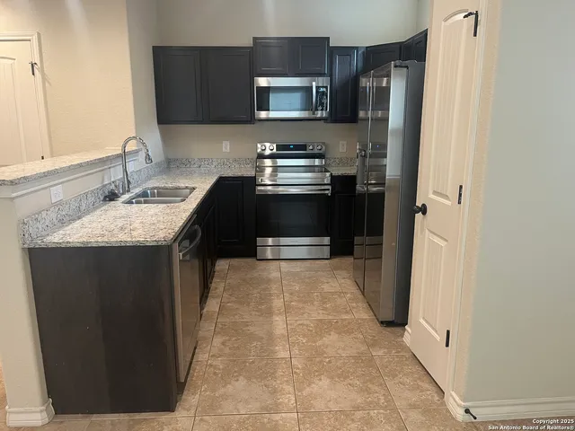 a kitchen with a sink stove and refrigerator