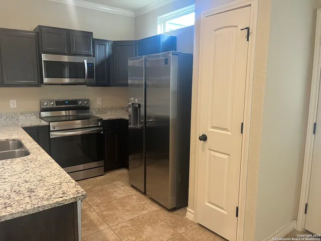a kitchen with a refrigerator stove and microwave