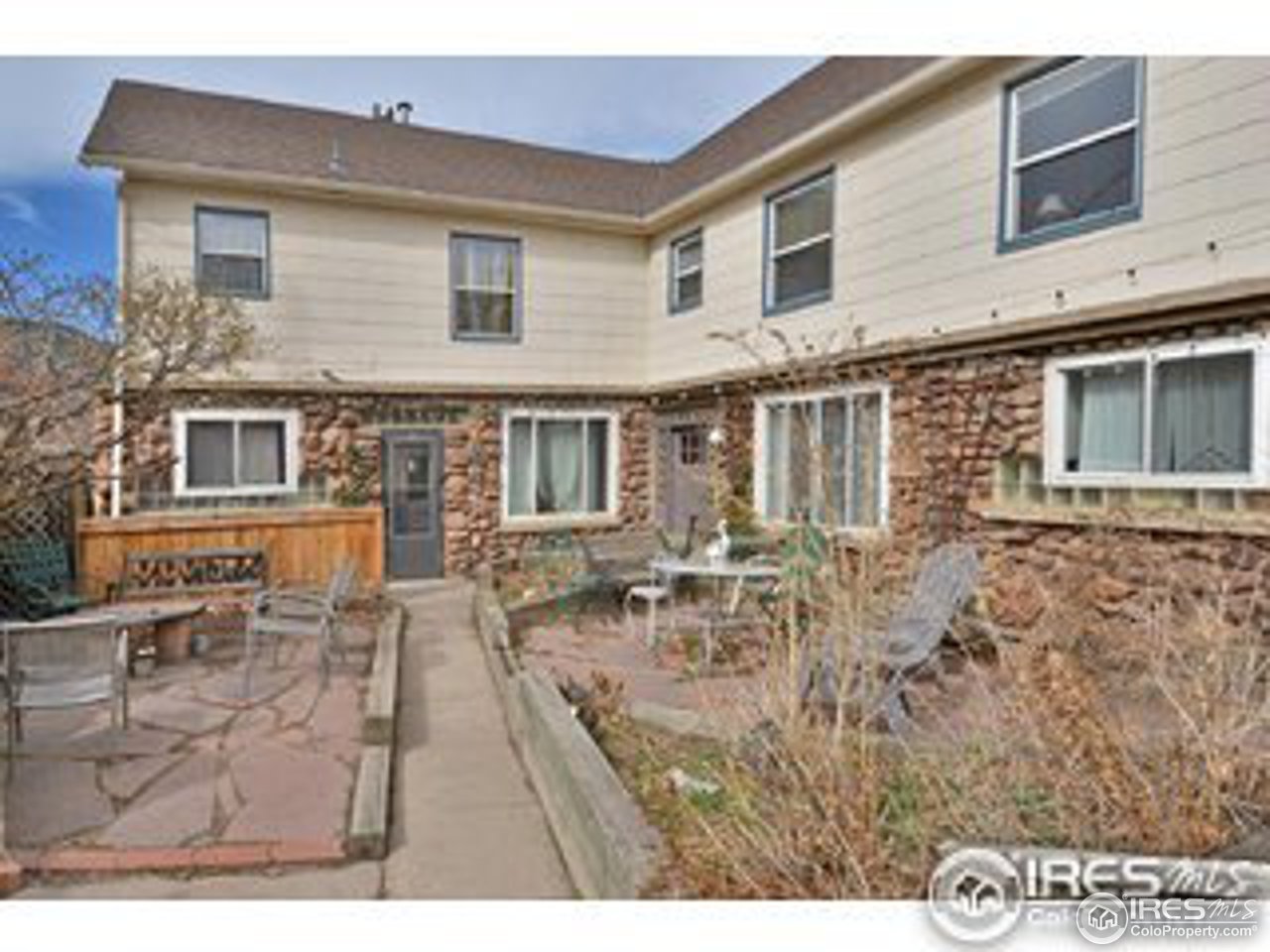 a backyard of a house with table and chairs