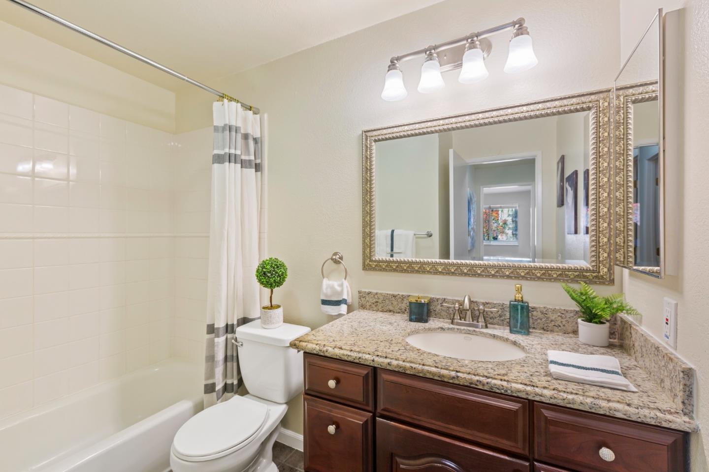 2250 Monroe Street, Unit 111 Santa Clara, CA 95050 - Photo 13 of 20 a bathroom with a granite countertop sink a toilet and shower