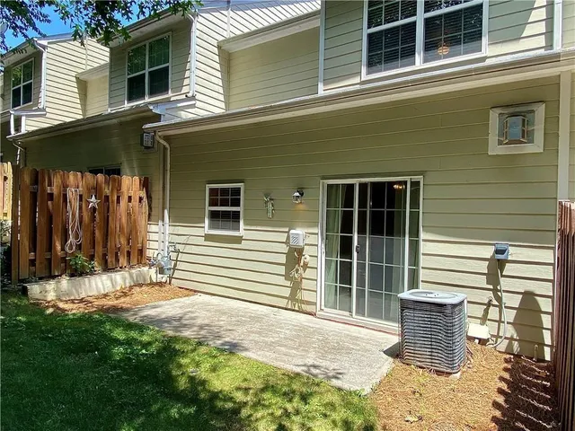 a view of a house with a large window and a yard