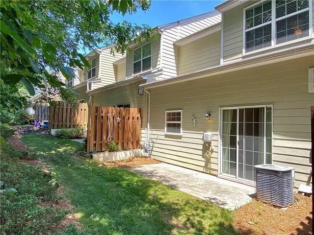 a view of a house with backyard and sitting area