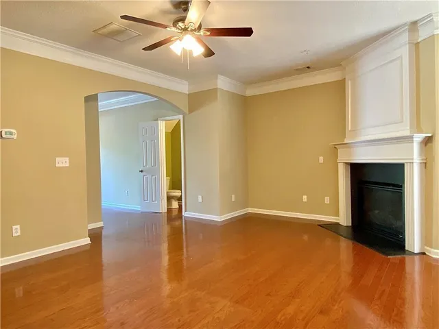 a view of an empty room with a fireplace and a window