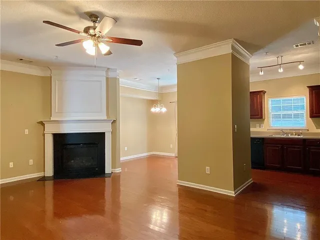 a view of an empty room with a fireplace and a window