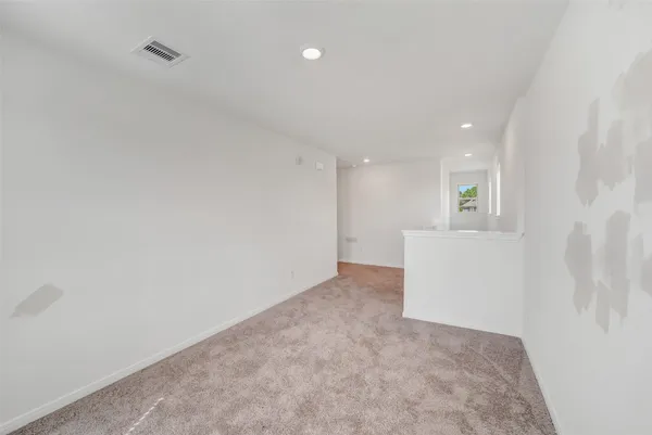 a view of an empty room and a window
