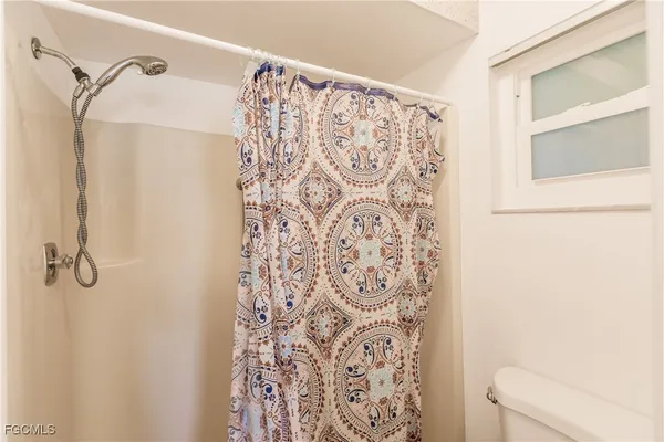 a bathroom with a shower curtain and a shower curtain