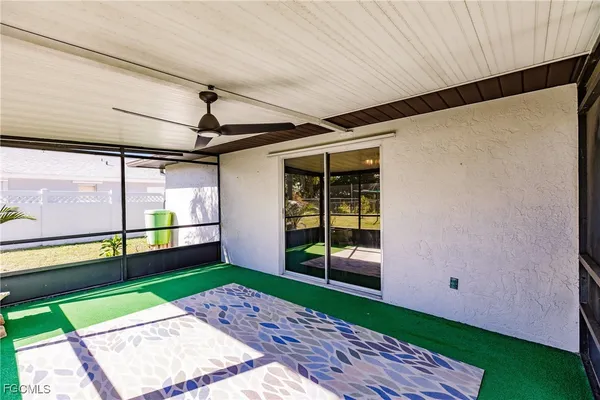 a view of a porch with a floor to ceiling window and wooden floor