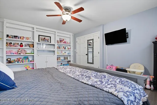 a bedroom with a bed and a book shelf