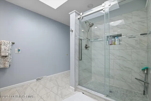 a bathroom with a glass shower door
