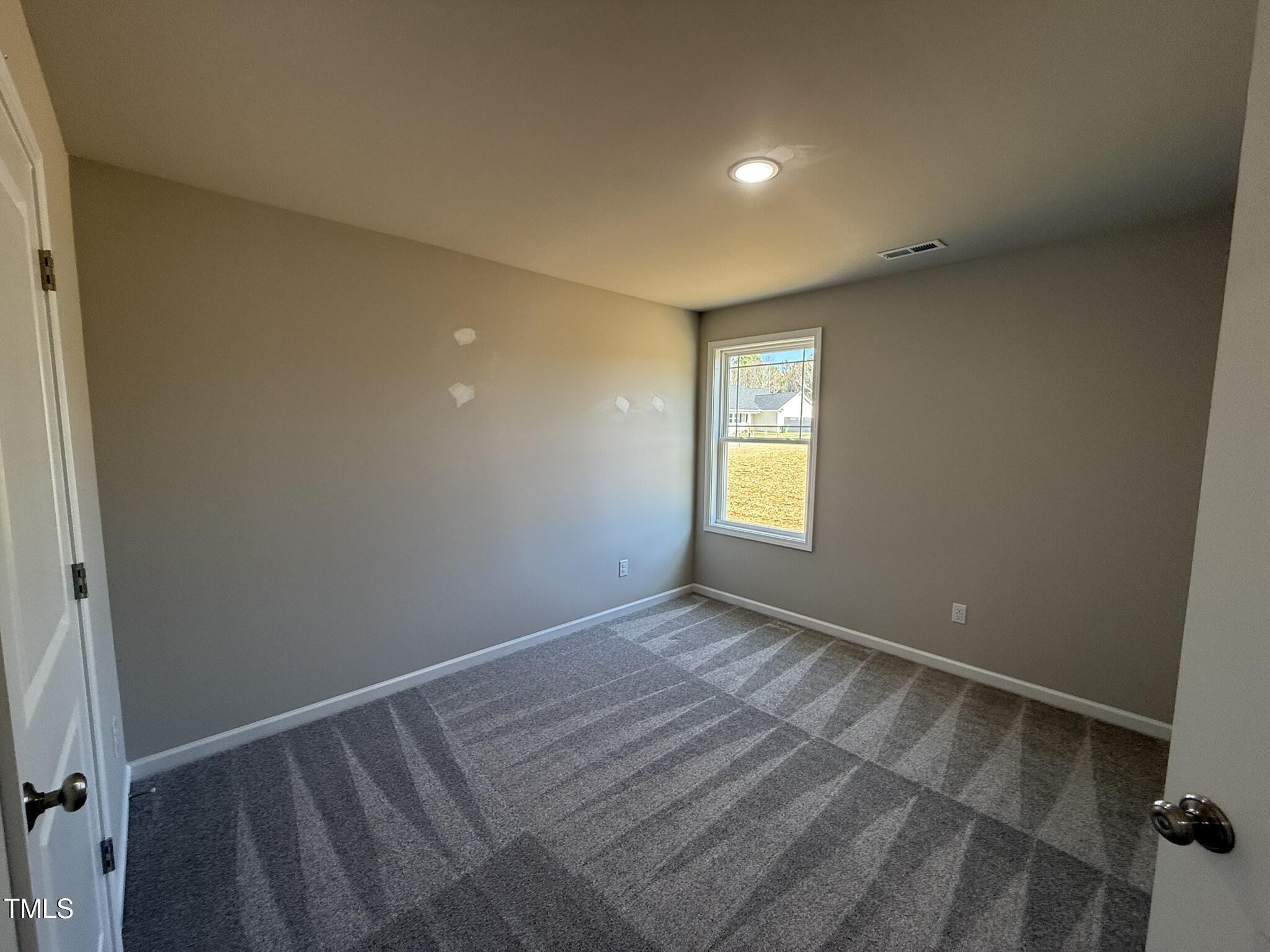 175 Magnolia Run Way Benson, NC 27504 - Photo 11 of 19 a view of an empty room with a window