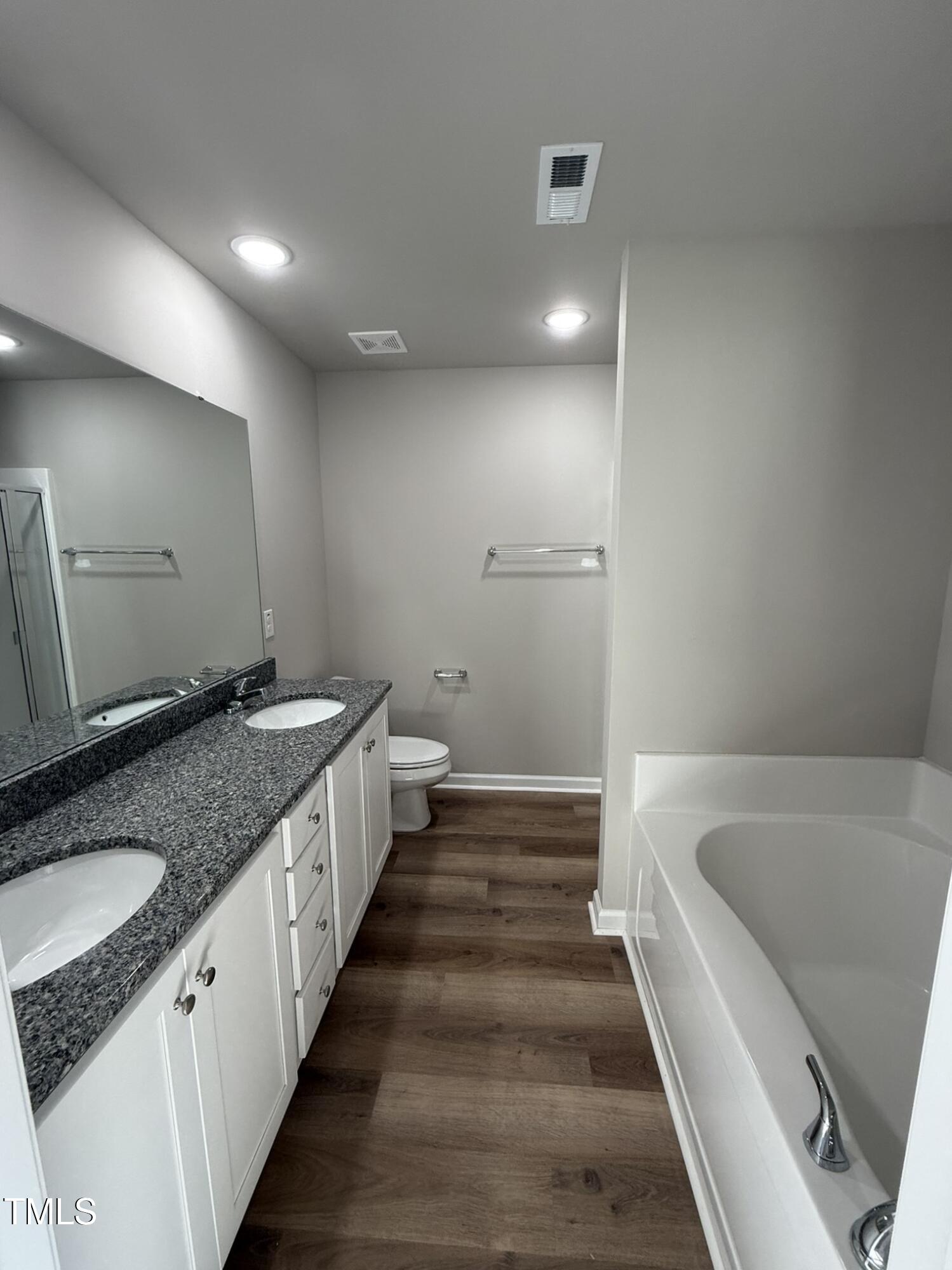 175 Magnolia Run Way Benson, NC 27504 - Photo 15 of 19 a bathroom with a granite countertop sink and a bathtub