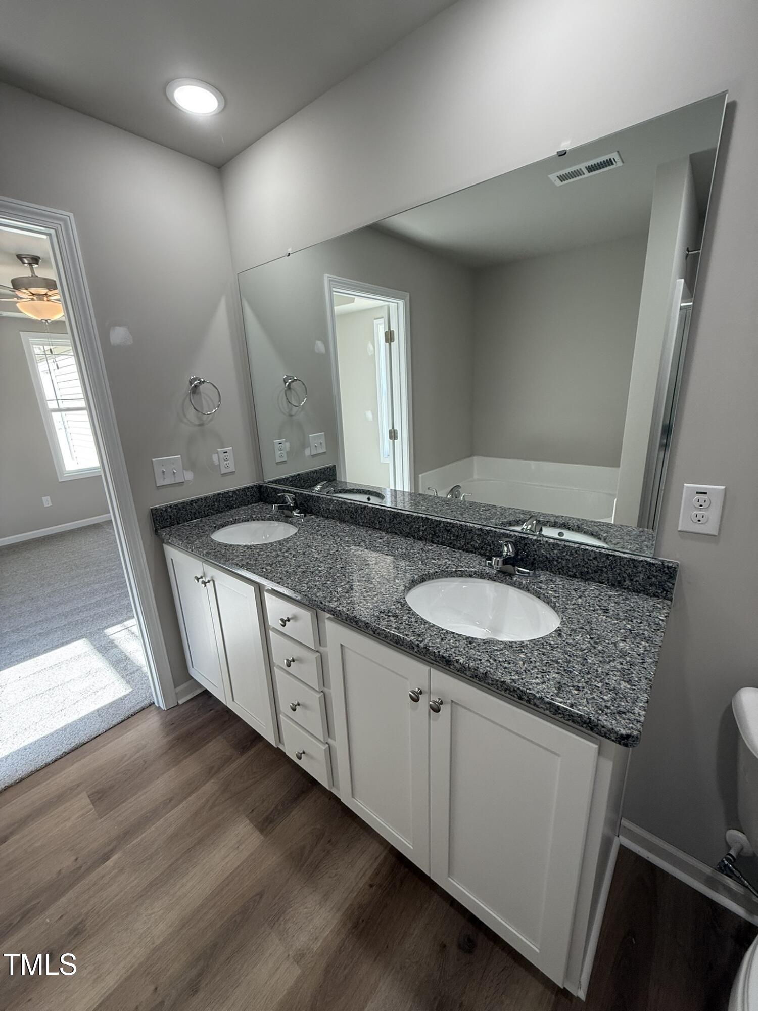 175 Magnolia Run Way Benson, NC 27504 - Photo 16 of 19 a bathroom with a granite countertop sink and a mirror